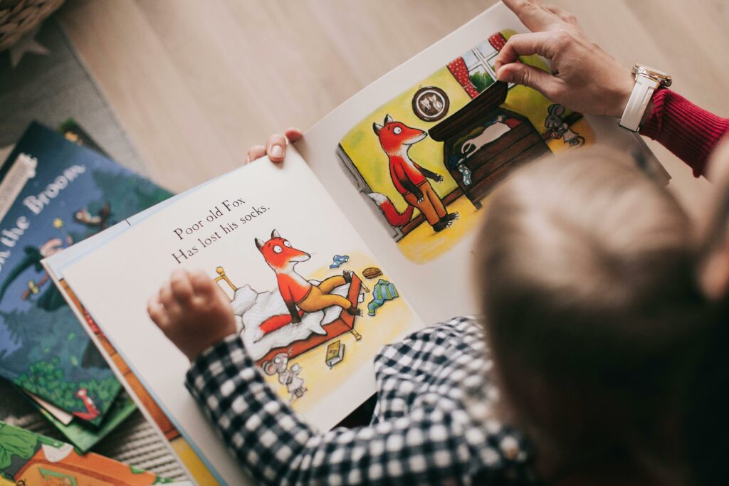 the costs of childcare 
A baby on his mother's lap, reading a book